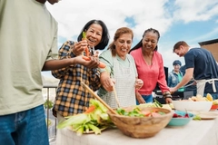Image Multigenerational Multiracial people doing barbecue at home's rooftop, preparing veggies on table