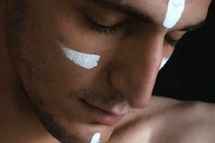Image A man with stripes of white on his face.