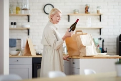 Image woman looking at wine bottle
