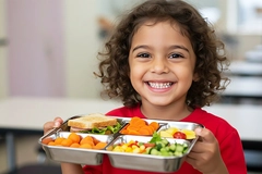 Young girl with a healthy school meal.