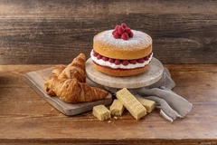 Image cake and croissant on brown table