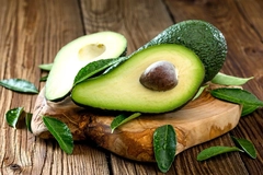 Image cut avocado on wooden table
