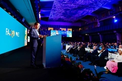 Image speaker on stage with audience below