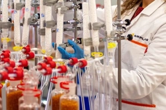 Image scientist looking at tube