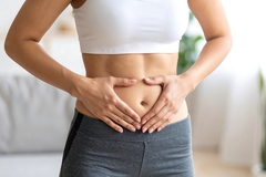 Image Woman holding her belly
