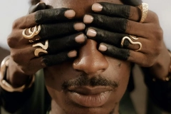 Image henna hands holding a man's eyes closed