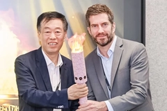 Two men holding a torch