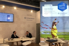 Image two people sitting in booth with poster on glp-1