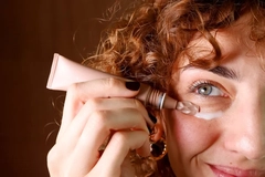 Image woman applying skin cream