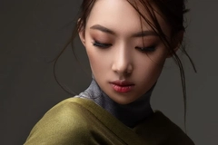 Image korean woman in green top looking downwards