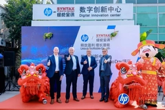 Image A group of men standing in front of a sign