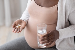 Image Pregnant woman taking supplements