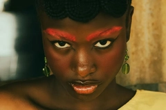 Image woman with red eyebrows looking directly into camera