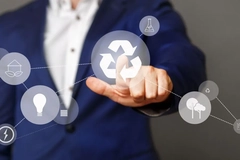 A person touching a touch screen with a recycle symbol