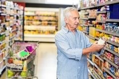 Image Shopper reading food labels in the supermarket.