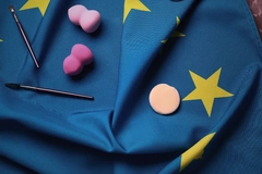 Image makeup products laying on the EU flag on a flat surface