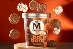 Image round pieces of unilever magnum ice cream floating over tub