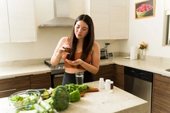 Image Woman taking a supplement