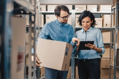 Image Man and woman in warehouse with boxes