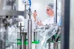 Image scientist holding plastic bottle in lab