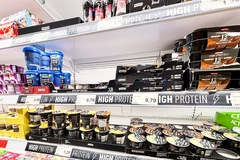 Image High-protein food products in supermarket.