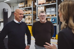 Image A group of men in a warehouse