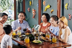 Image Asian family enjoying food at the table.