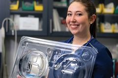 Image Woman holding medical packaging.