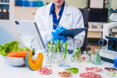 Image female scientist in lab with food samples