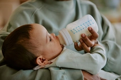 Image Parent feeding a baby infant formula