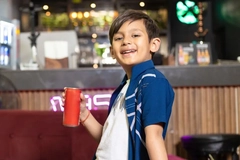 boy drinking from can