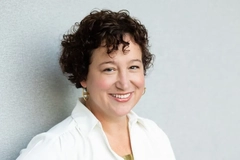 A woman smiling into the camera