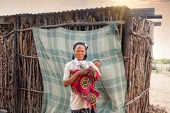 Image San woman holding her child