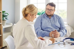 Image Doctor talking to overweight patient