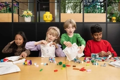Image A group of children taking out toys from paper bags