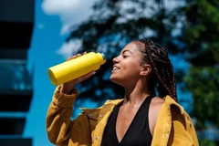 Image woman drinking from metal bottle