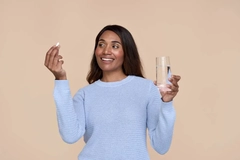 Image woman taking beauty from within supplement