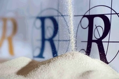 A close-up of material pouring out of a pile