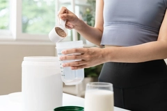 Image young sporty woman pouring protein powder into a cup