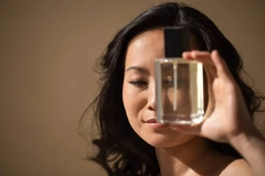 Woman holding perfume bottle