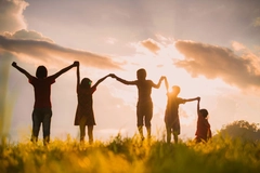 Image children hold hand against the sunset