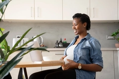 Pregnant woman working on a laptop