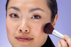 woman applying blush