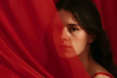 Woman behind a red veil