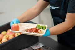 Image A person serving a tray of food