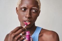 Person applying lipstick