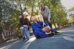 Seniors playing basketball outside