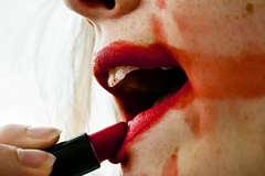 Image Woman with smeared lipstick applying more