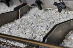 Close-up of a machine with a pile of crushed material