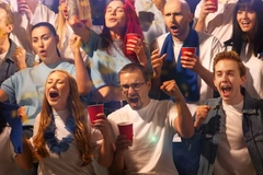 Image people watching sport drinking